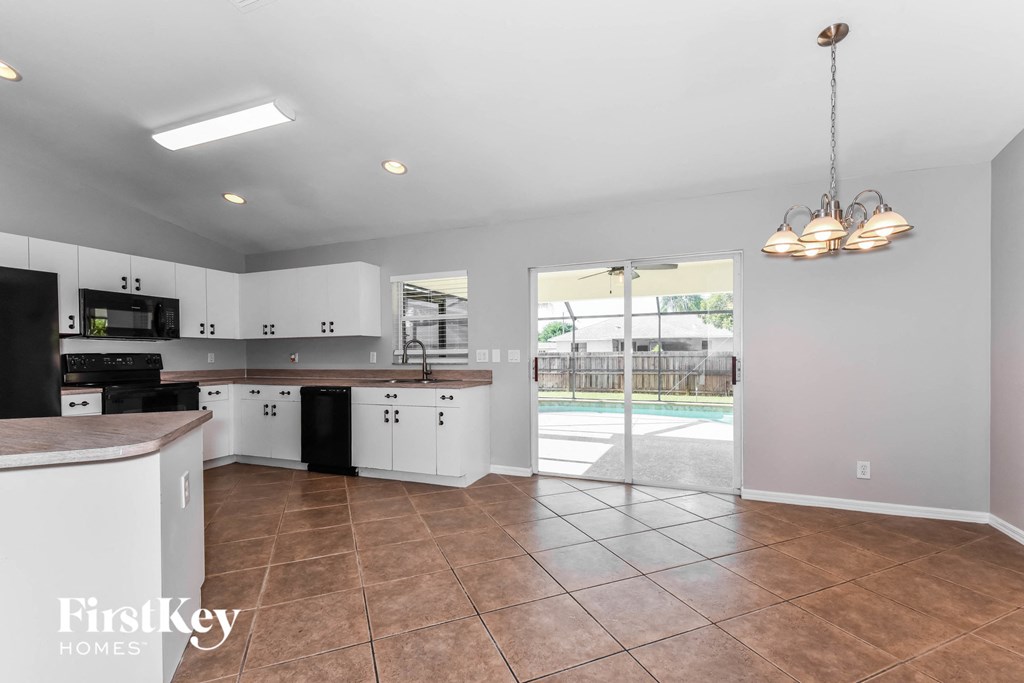 a kitchen with a sliding glass door to the pool
