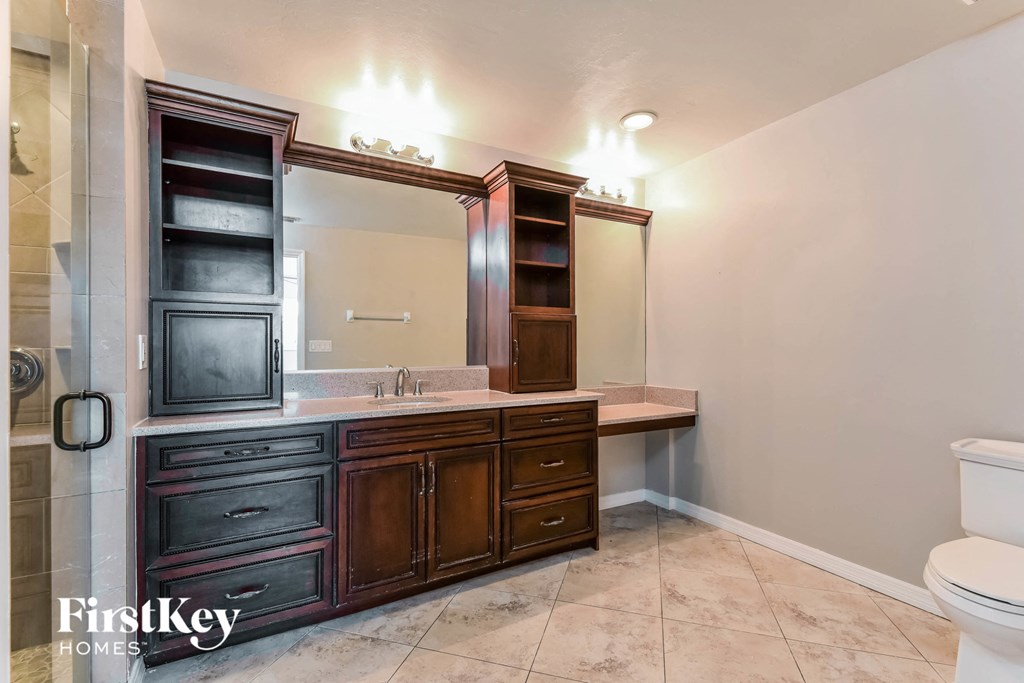 a bathroom with a sink and a toilet and a mirror