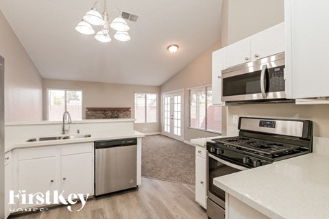 A kitchen with white cabinets and a stainless steel dishwasher.