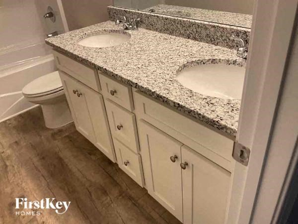 a bathroom with two sinks and a toilet