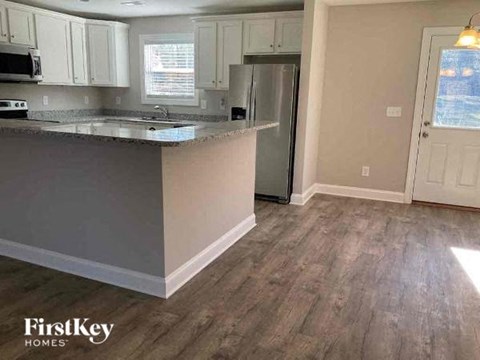 a kitchen with a counter top and a refrigerator