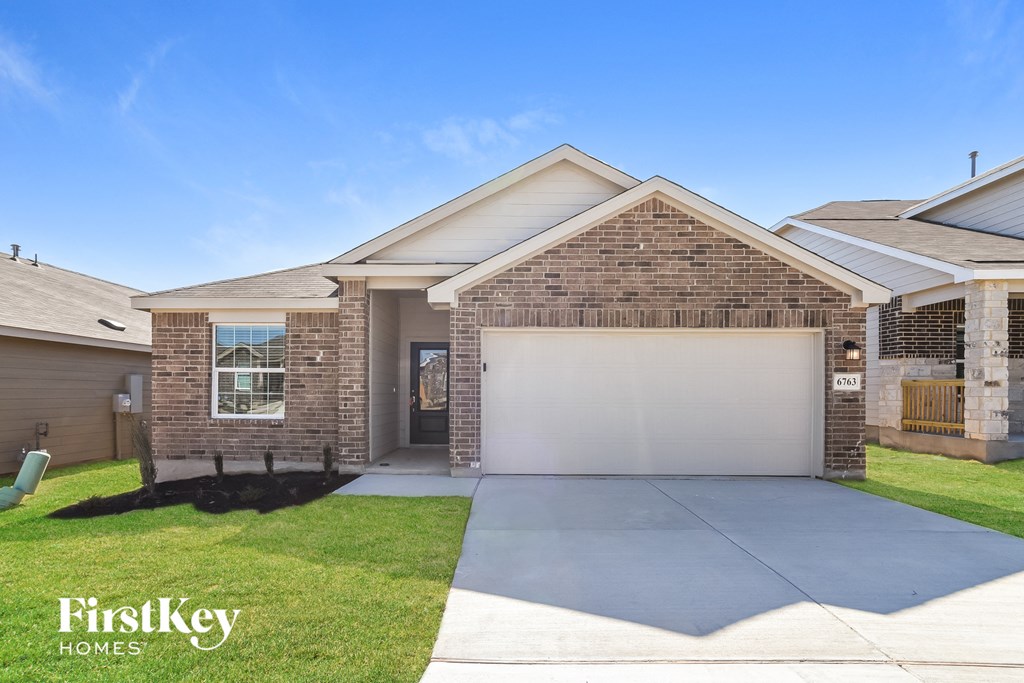 A house with a garage and a driveway is for sale.