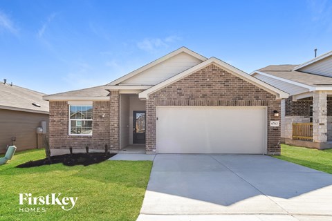A house with a garage and a driveway is for sale.