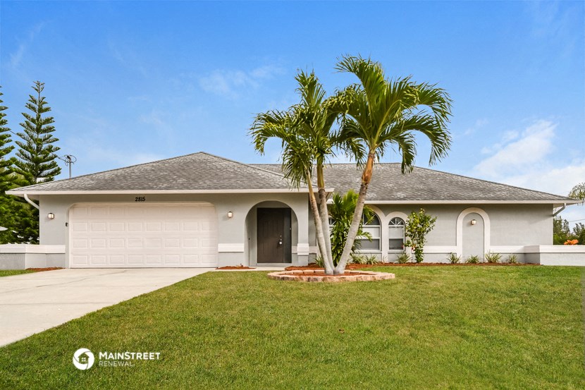 a house with a palm tree in front of it