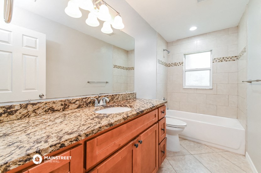a bathroom with a sink and a toilet and a bath tub