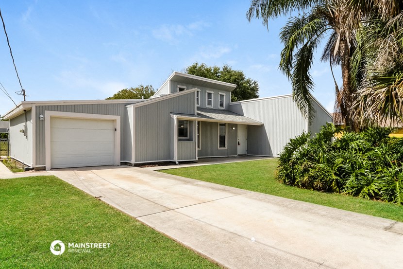 a white house with a garage and a driveway