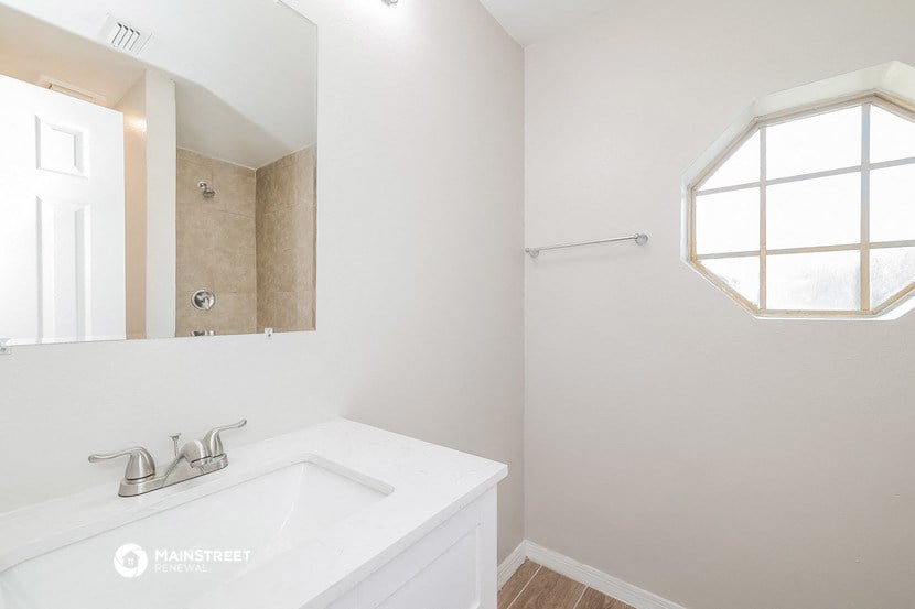 a white bathroom with a sink and a mirror
