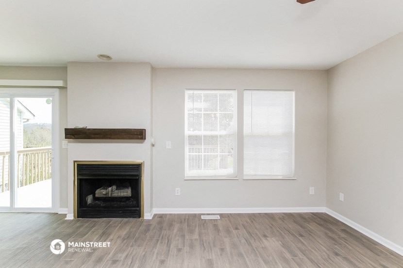 a living room with a fireplace and a sliding glass door