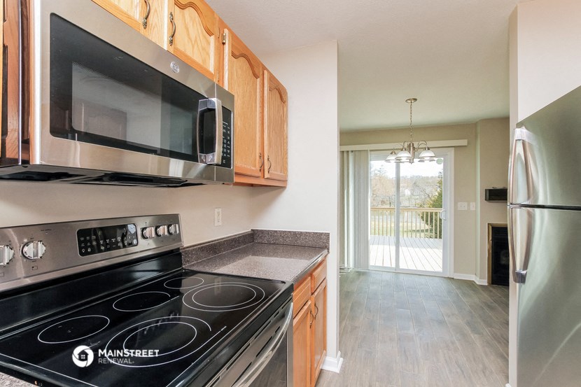 a kitchen with stainless steel appliances and a microwave