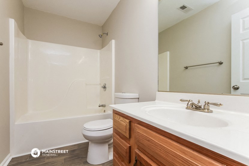 a bathroom with a sink and a toilet and a shower