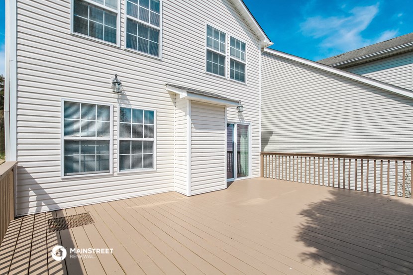 a white house with a wooden deck