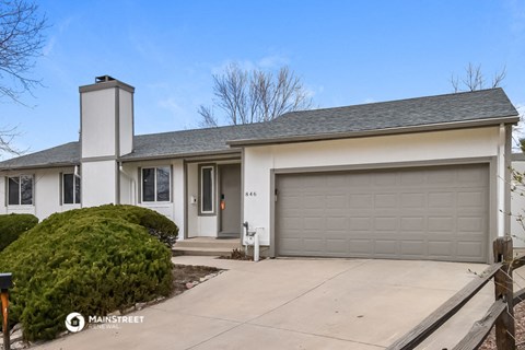 a white house with a driveway and a garage door