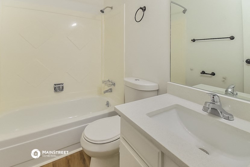 a bathroom with a sink toilet and a tub