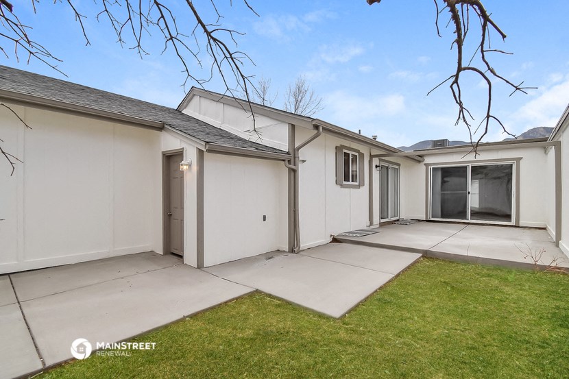 a white house with a driveway and a yard