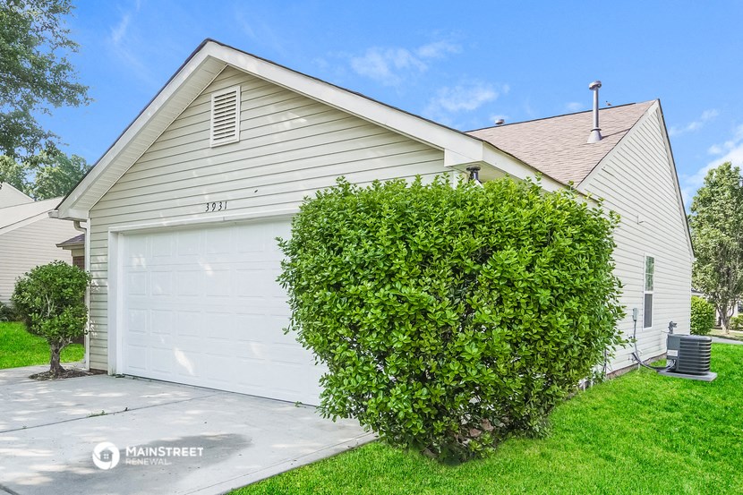 a white garage door in front of a white house