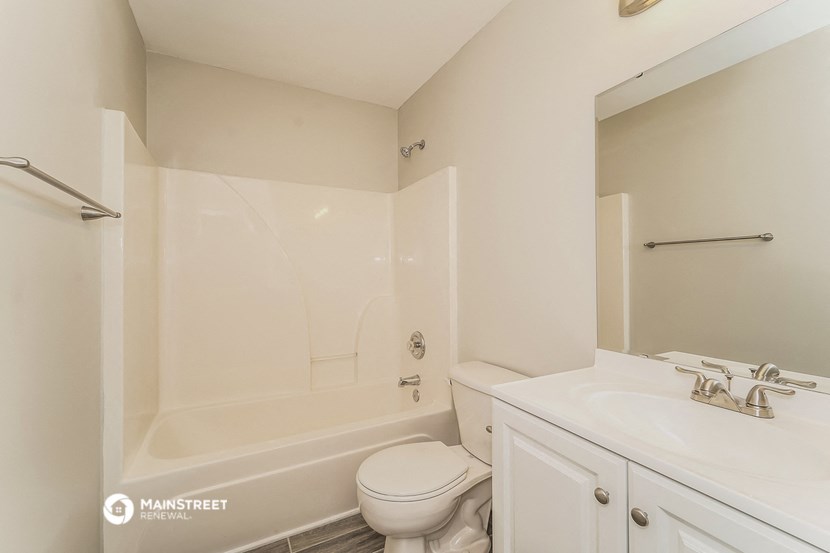 a bathroom with a sink toilet and a tub