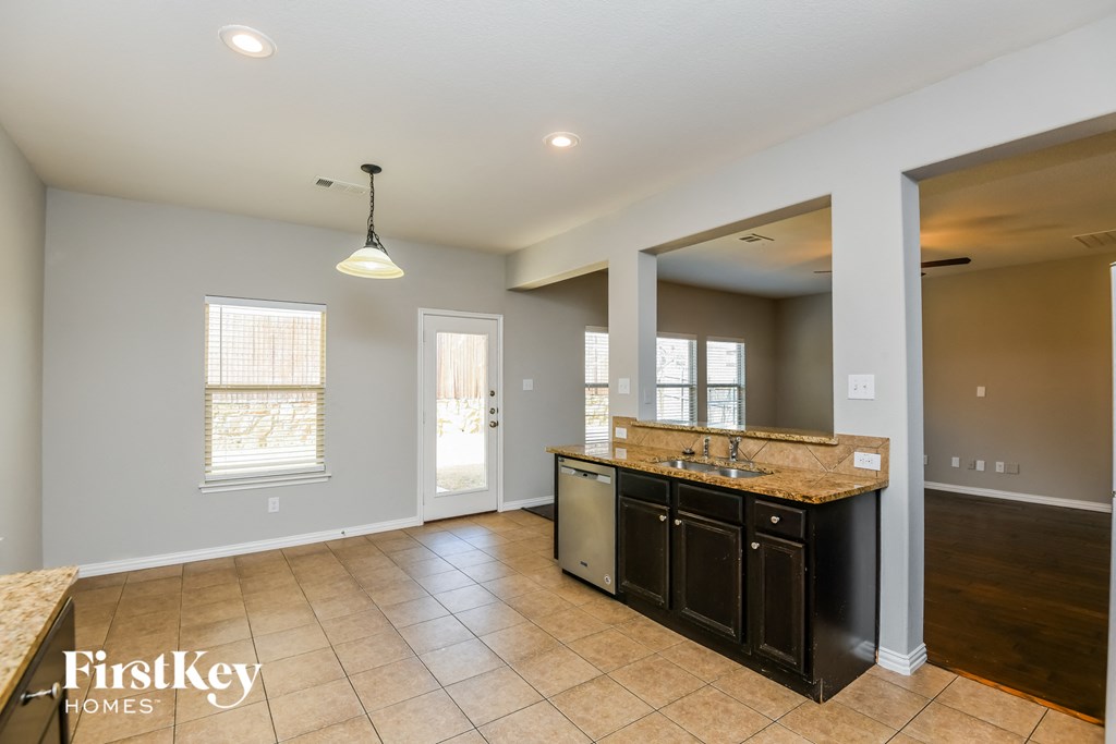 an empty kitchen with a sink and a counter top