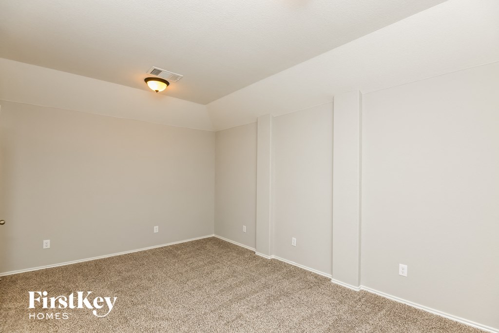 a bedroom with a carpeted floor and white walls