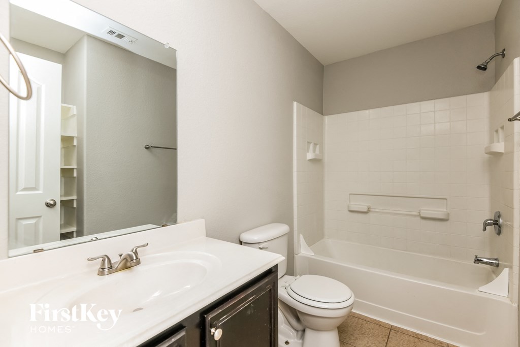 a bathroom with a sink and a toilet and a bath tub