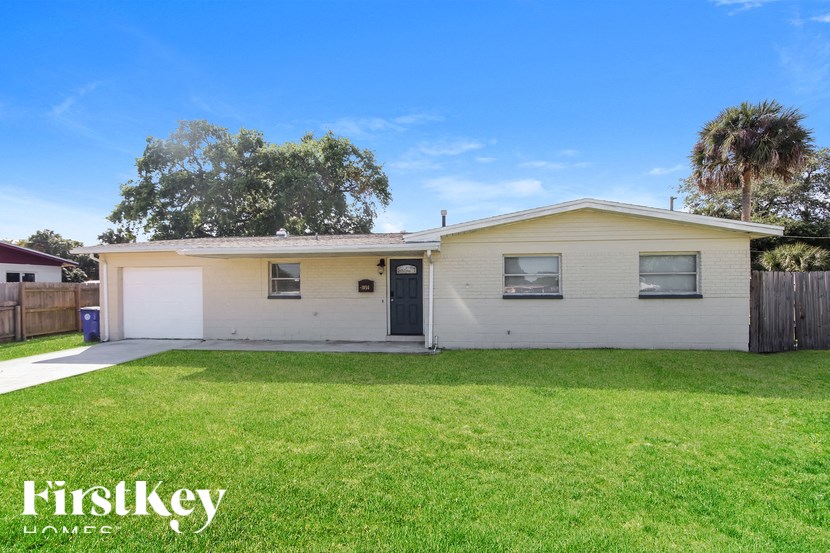 A two-story house with a garage is for sale.