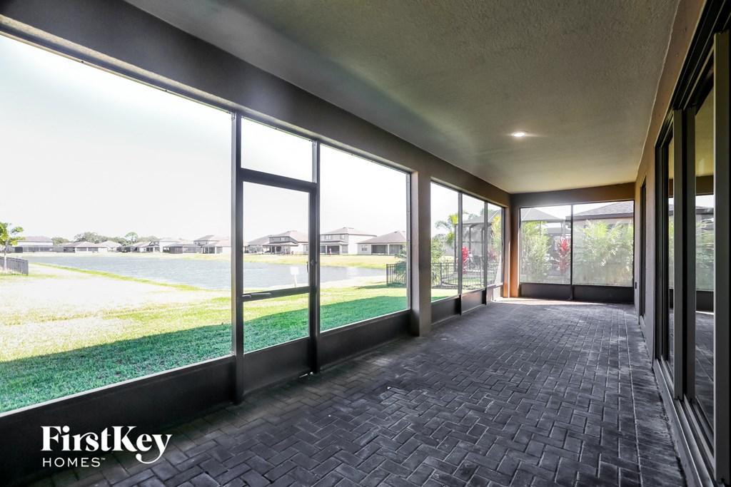 a long corridor with large windows and a view of a lake