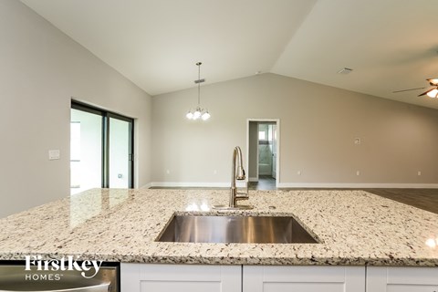 a kitchen with granite counter tops and a sink