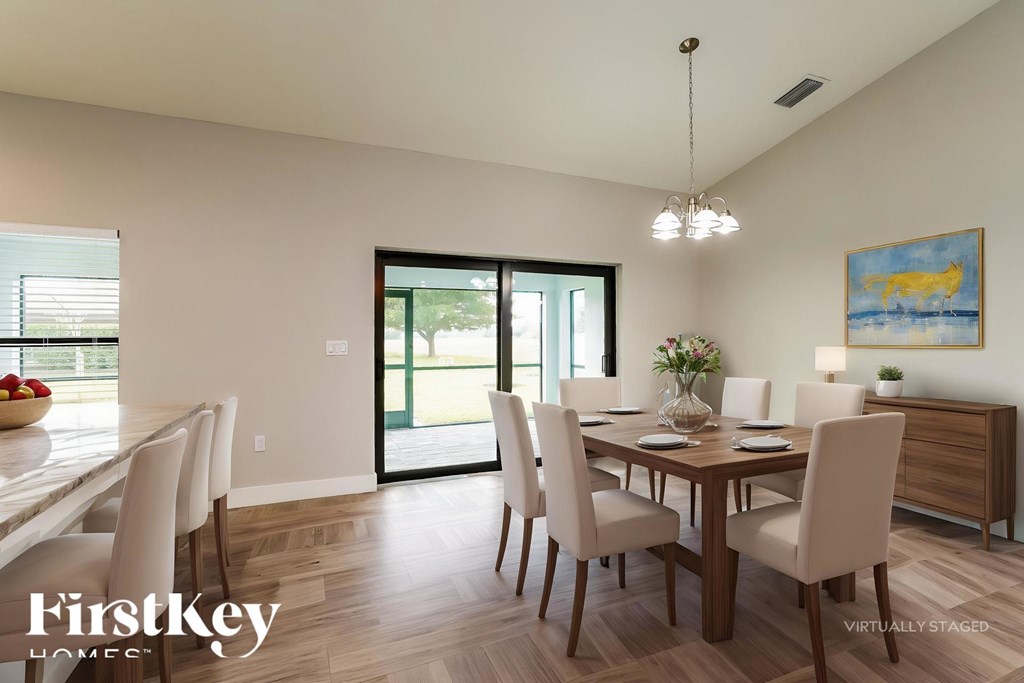 A dining room with a wooden table and chairs.