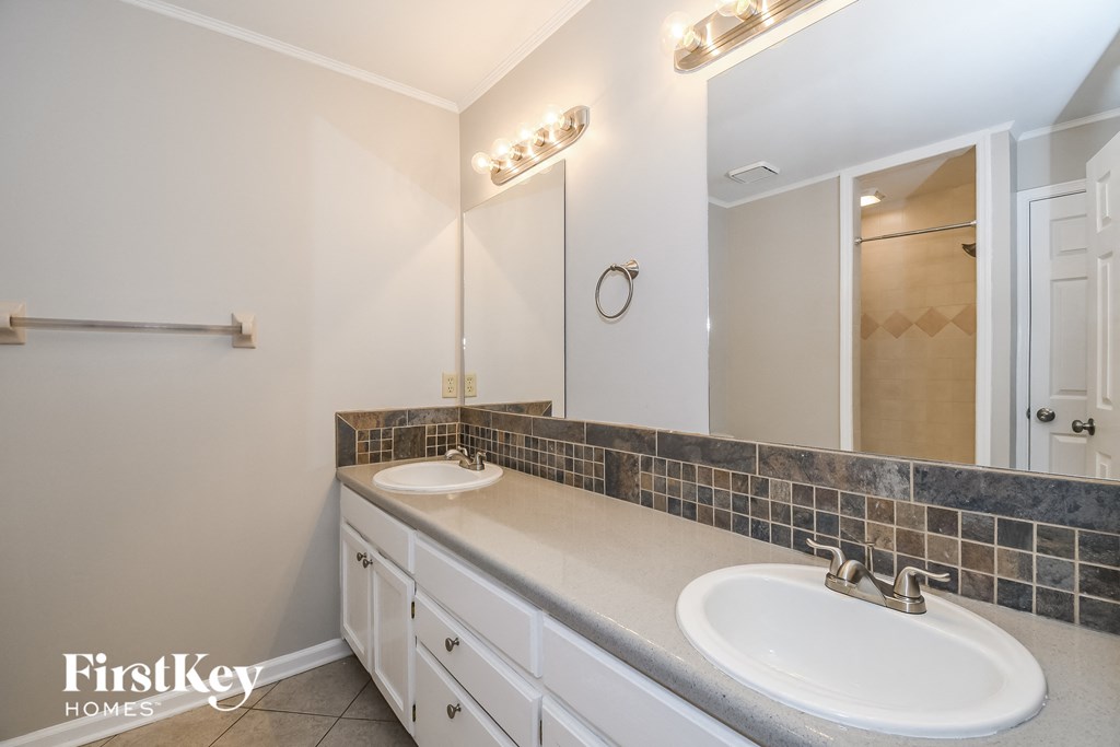 a bathroom with two sinks and a large mirror