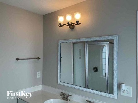 a bathroom with a mirror and a sink