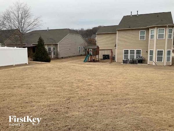 a backyard of a house with a yard and a playground