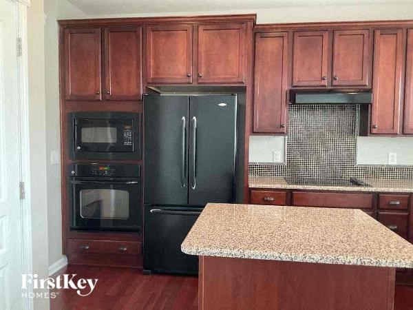 a kitchen with black appliances and granite counter tops