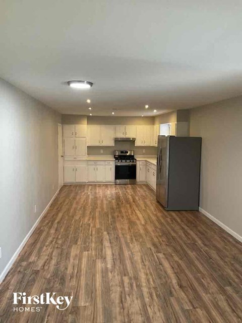 A kitchen with wooden floors and white walls.