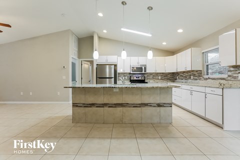 a large kitchen with white cabinets and a counter top
