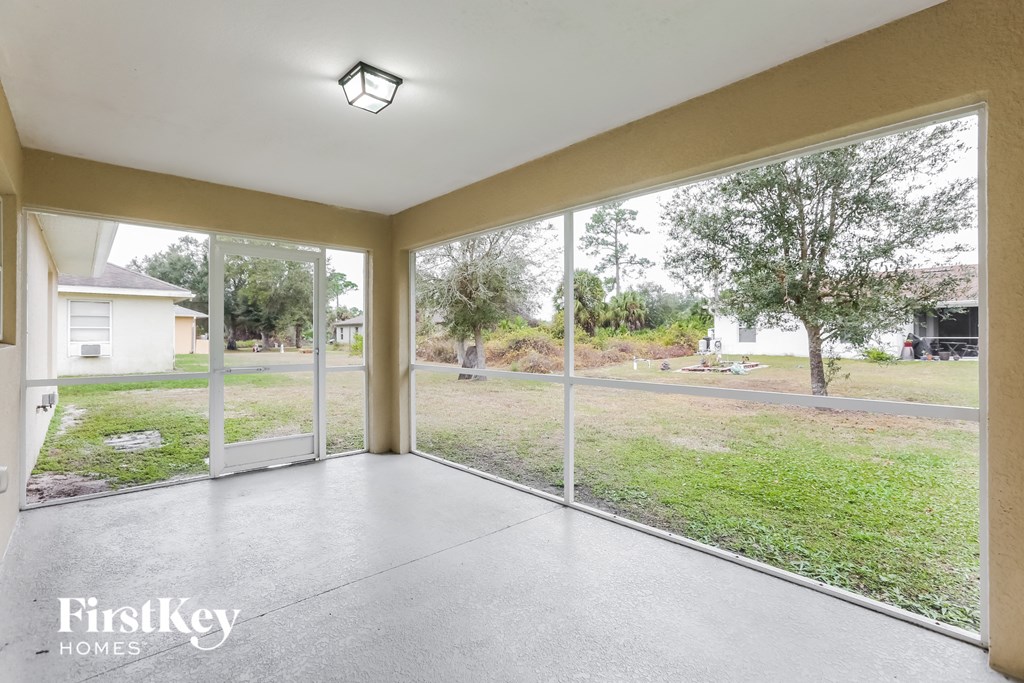 a living room with large windows and a view of the yard