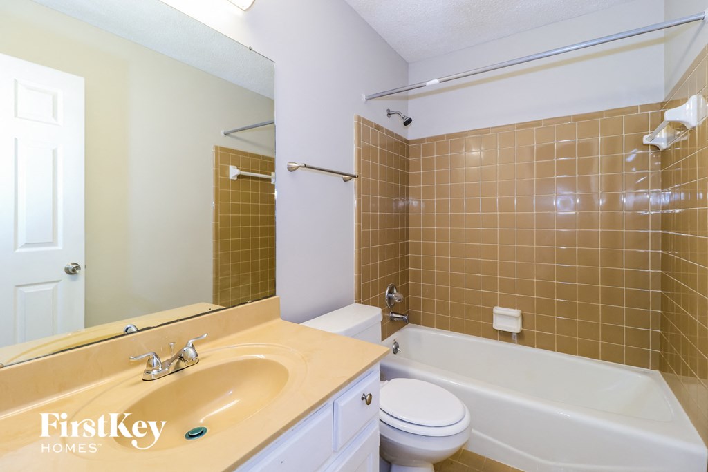 a bathroom with a sink and a tub and a toilet