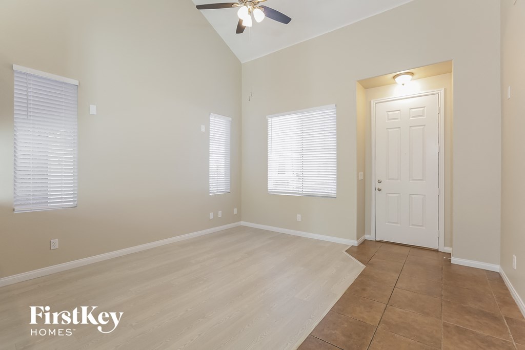 a living room with a tile floor and a white door