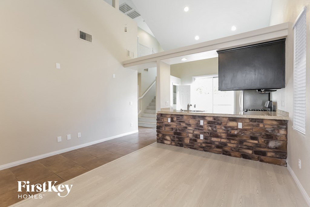 a living room with a fireplace and a tv on the wall