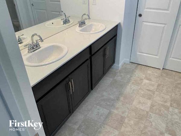 a bathroom with two sinks and a door