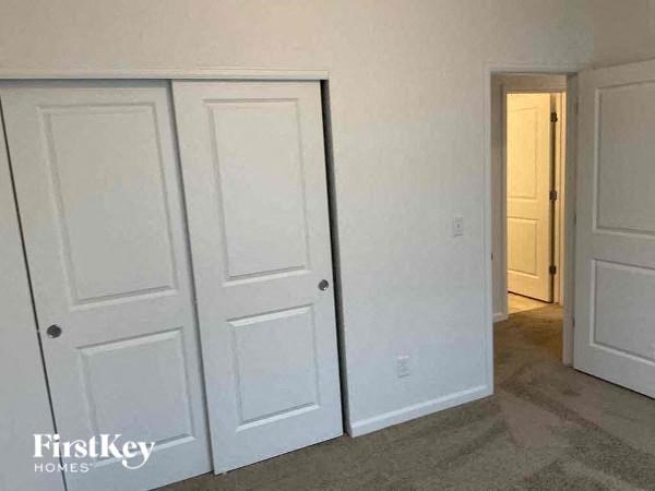 a bedroom with white doors and a door to a hallway