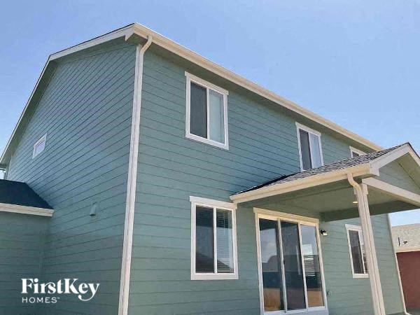 a green house with a blue sky