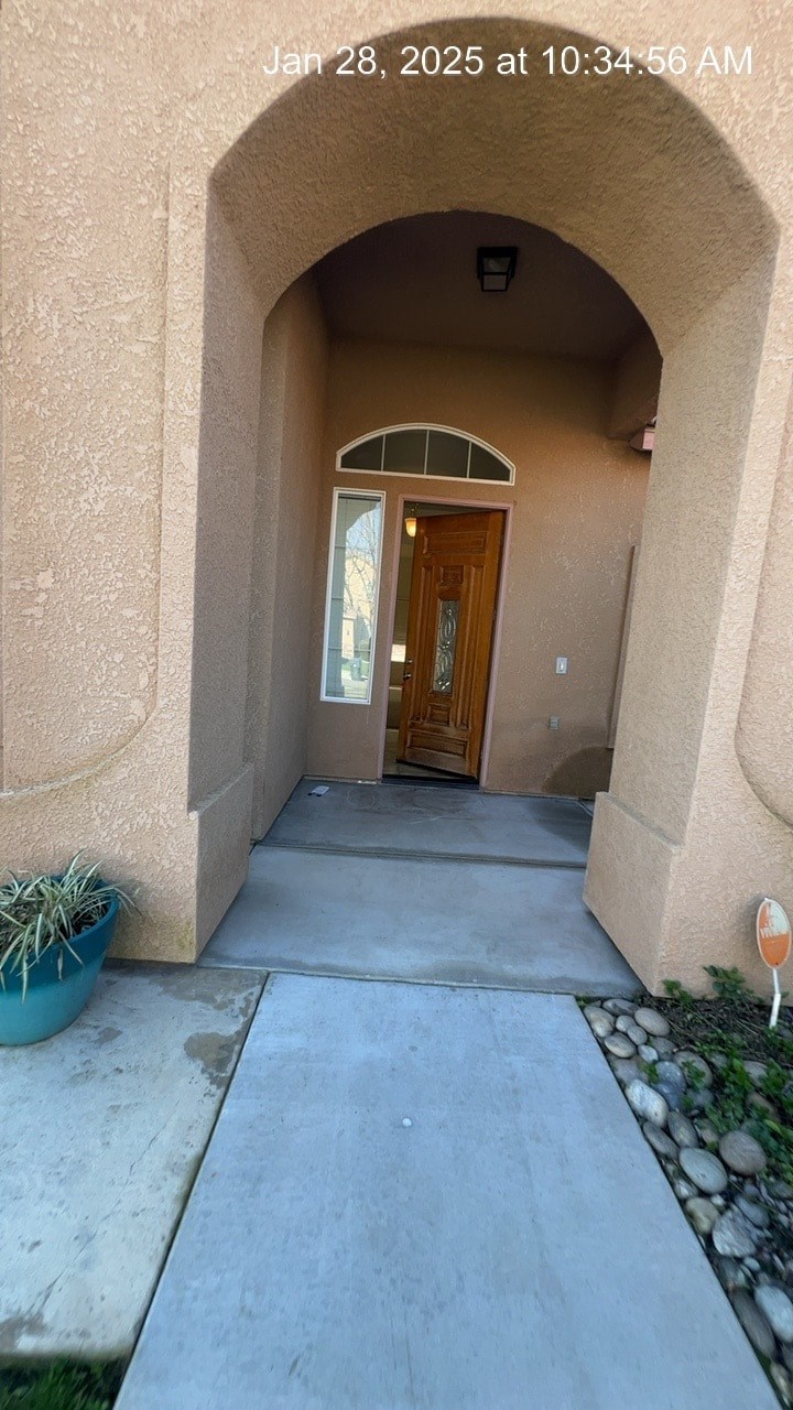A doorway is visible through an archway with a wooden door.