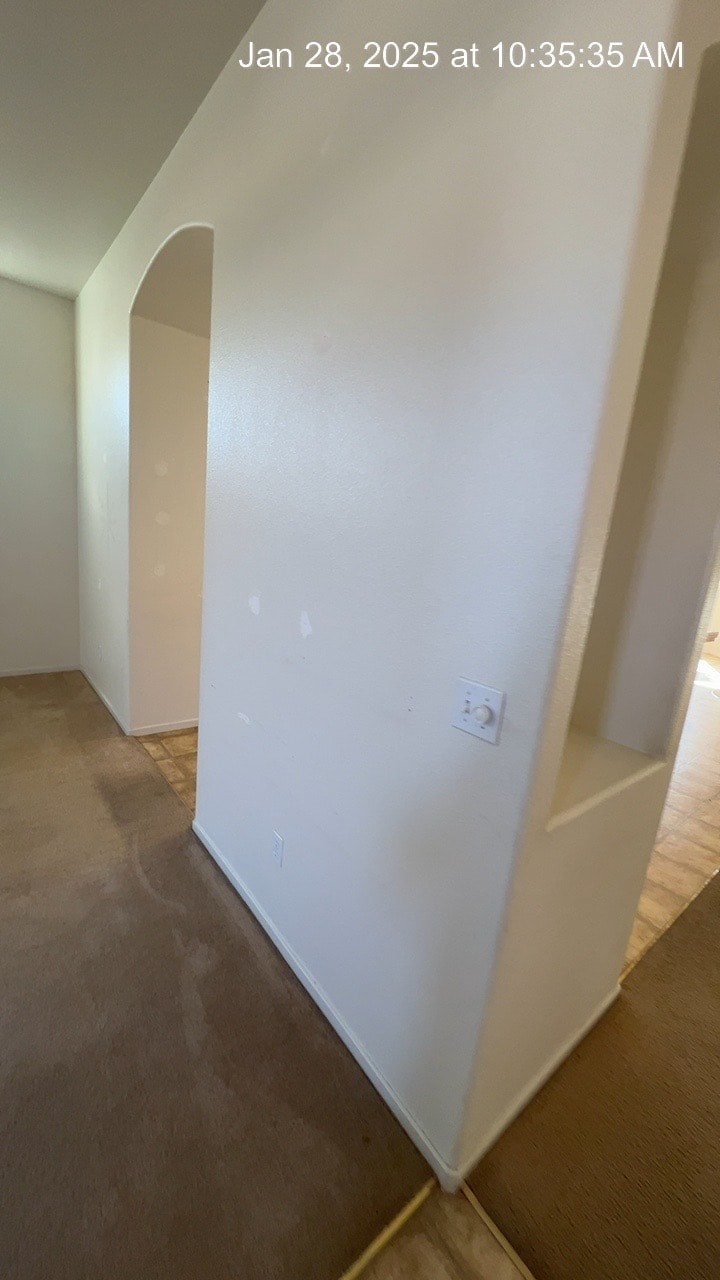 A white door is in a room with a brown floor.