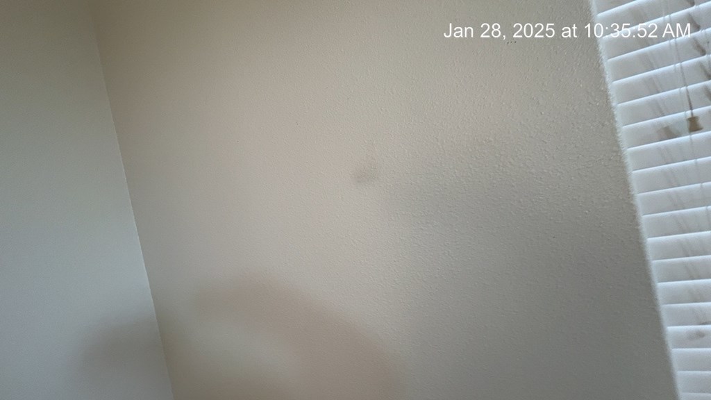 A wall with a date and time stamp on it.