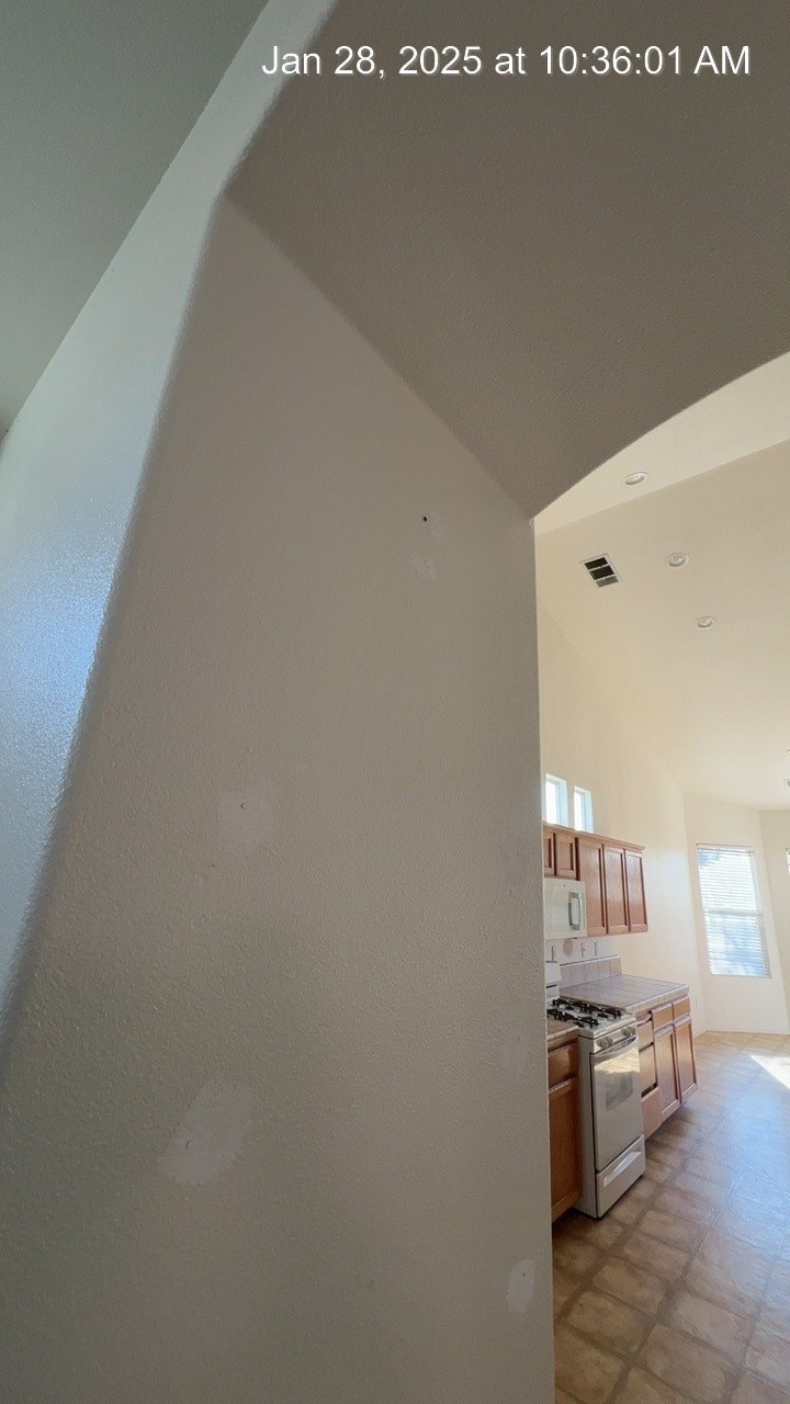 A kitchen with a stove and a window.