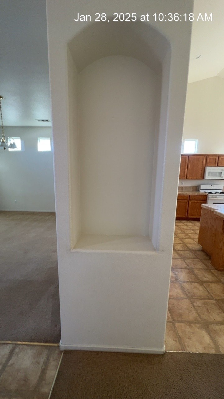A white doorway in a room with a tiled floor.