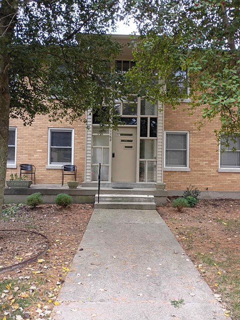 A brick building with a door and windows.