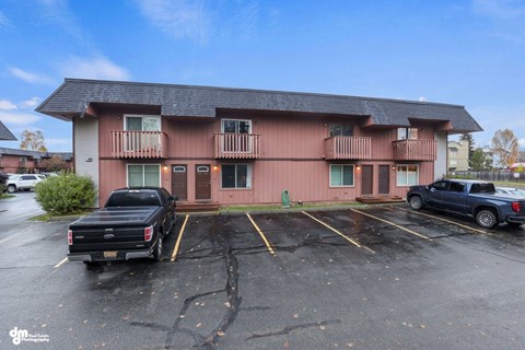 A building with a parking lot in front of it.