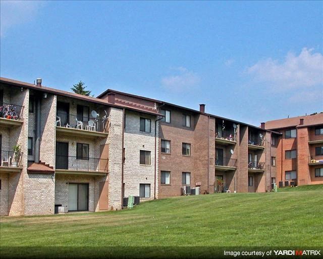 a group of apartment buildings on a green field