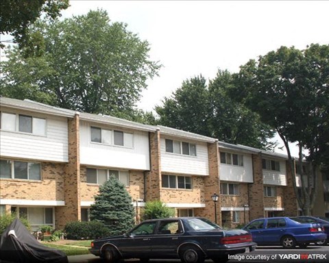 a apartment building with cars parked in front of it