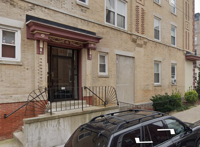 a car parked in front of a brick building